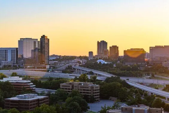 An aerial view of trees, highways and buildings in Tysons, Virginia.