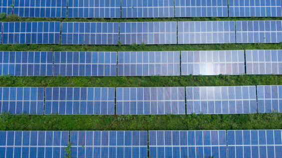 A row of solar panels is seen from a birds-eye view.