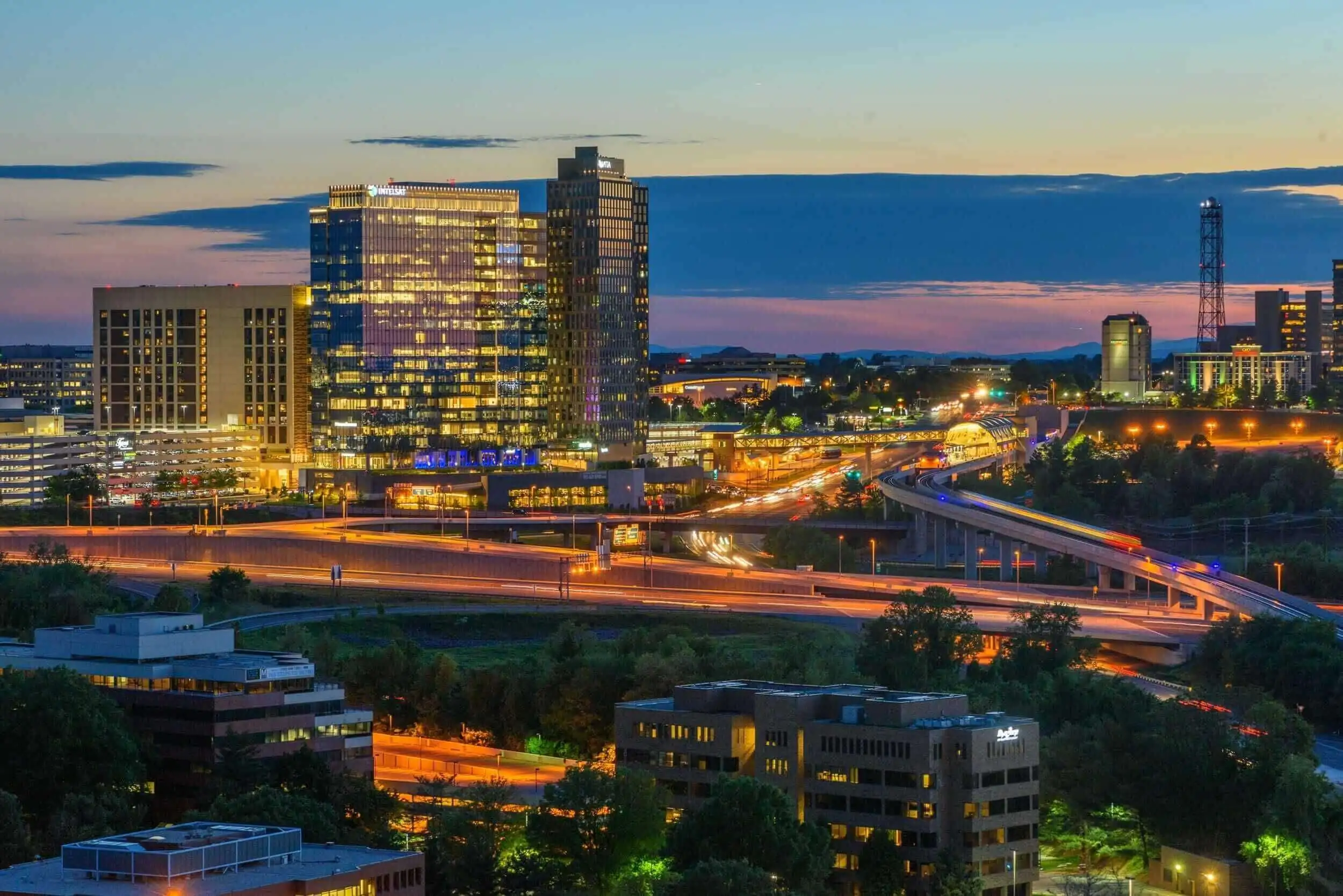 An aerial view of the highway and tall buildings at dusk in Arlington, Virginia.