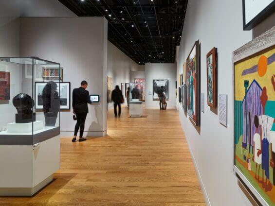 The interior of the National Museum of African American History & Culture as guests admire the art.