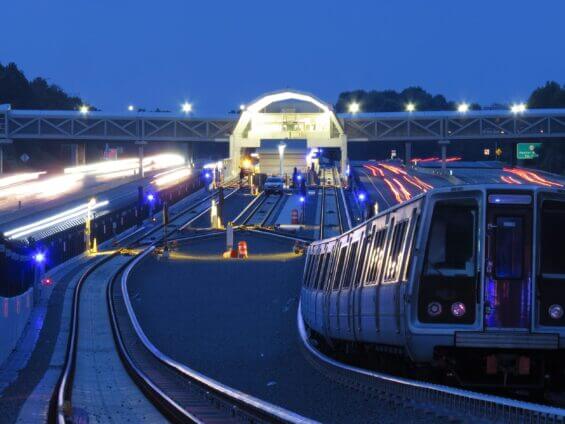 A brightly lit train station in Fairfax County at dusk.